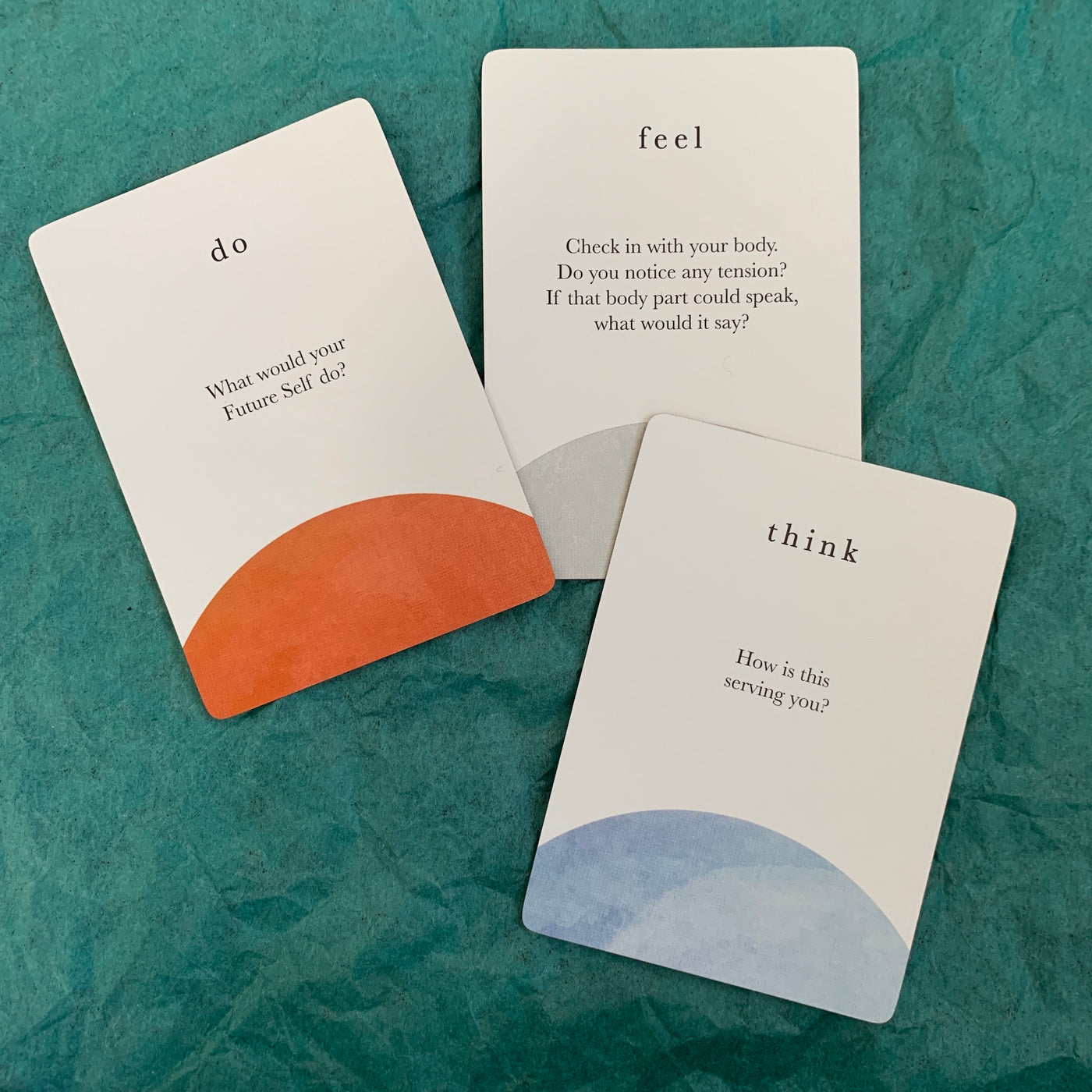 Three cards from the compass cards deck representing the think, feel and do categories