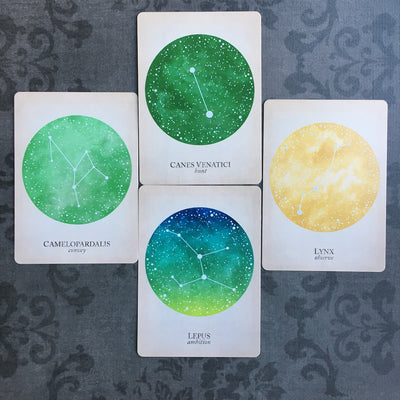 four cards with green and yellow night skies from The Compendium of Constellations by Black and the Moon: keyword edition 
