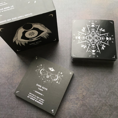 The Dark Days Tarot comes in a rigid two-piece box with a perfect-bound square guidebook that fits in the box. 