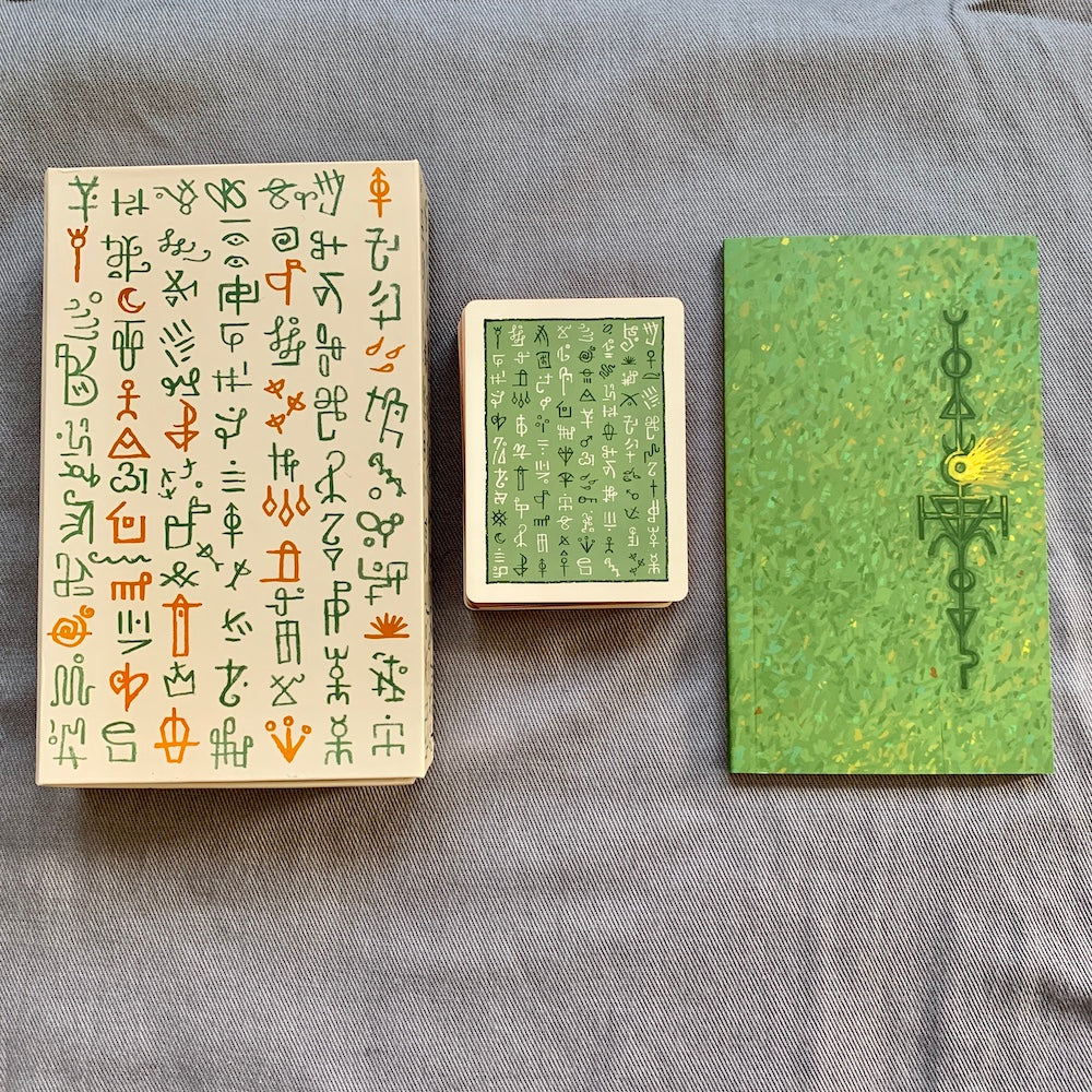 The box, guideboock and card backs for the Green Glyphs Lenormand