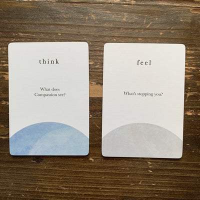close-up of cards from the compass cards deck asking What does compassion see? and What's stopping you?